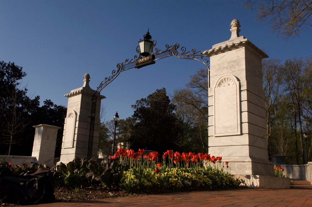 main gate at emory university with blue sky