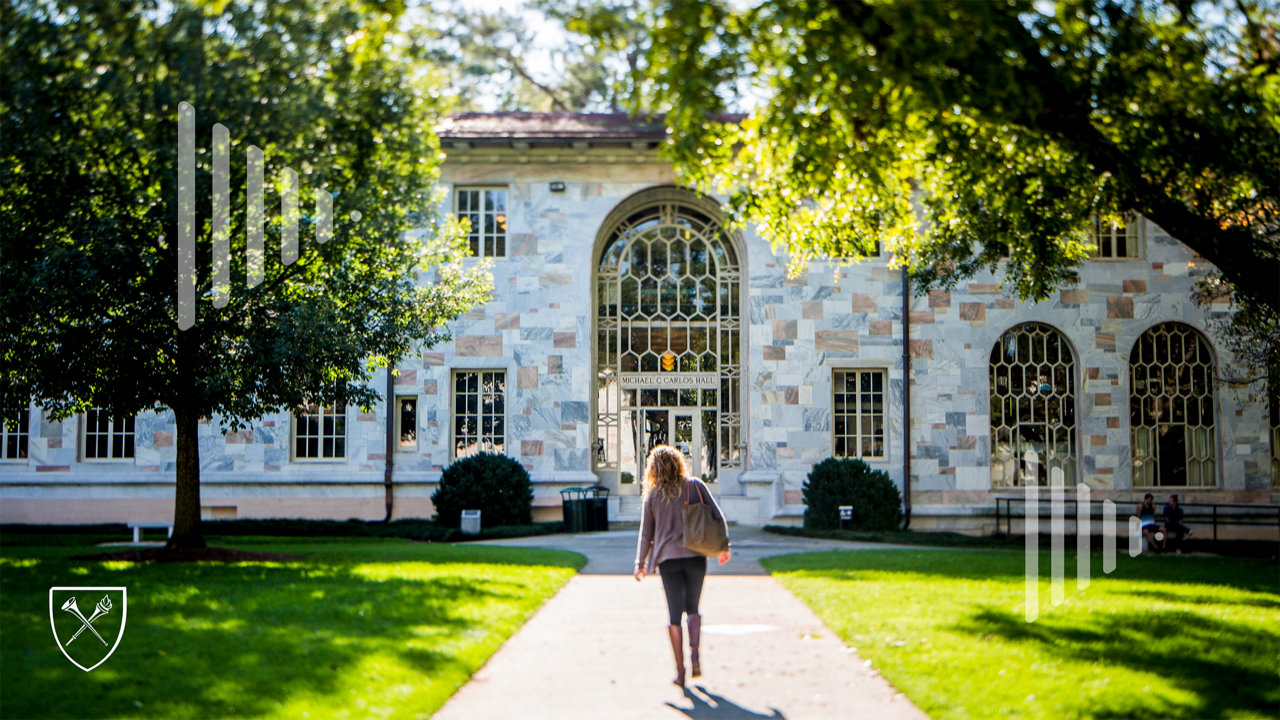 student walking toward carlos hall