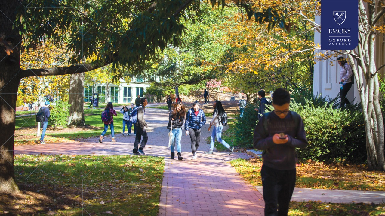 students walking outside at oxford college with fall leaves